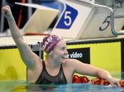 AROUND THE WORLD: Ariarne Titmus savours the moment after clinching the 400-metre freestyle world record. Picture: Delly Carr