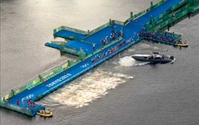 Boat race: Half the field jump in as a boat blocks the remaining competitors at the triathlon start in Tokyo. Picture: Channel 7