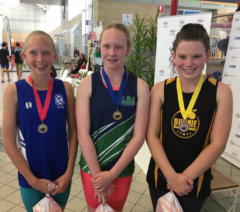 Podium #3: Amber French, of Sandy Bay, Amy Muldoon, of LAC, and Zali Munday, of Burnie, after the 12-13 200m backstroke.