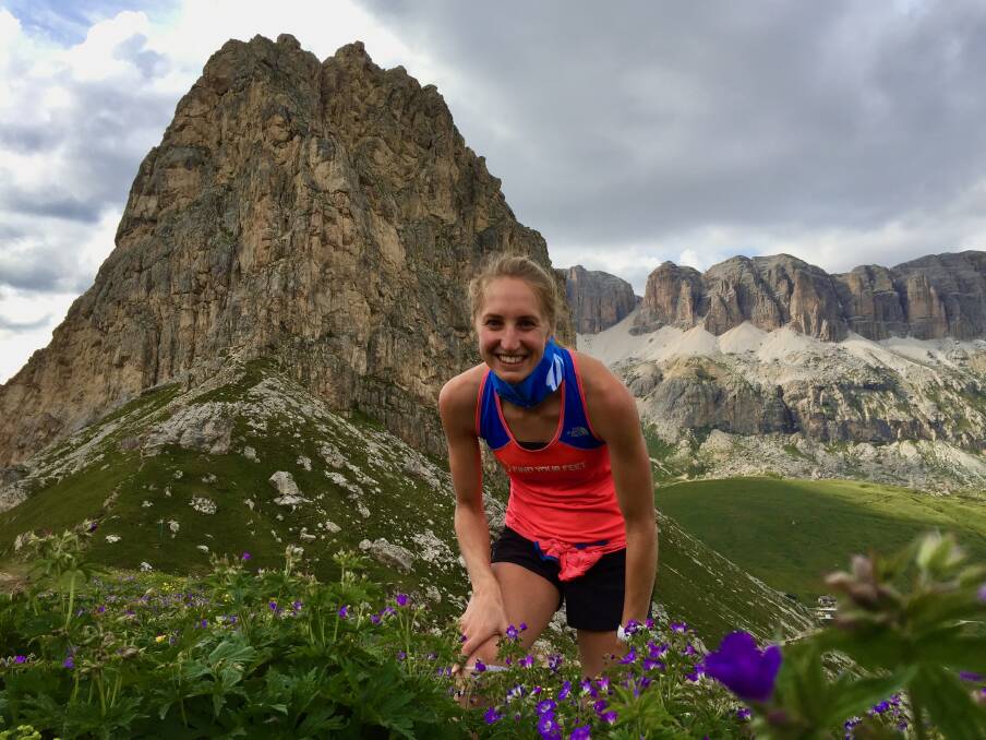 Hanny Allston pauses to smell the flowers while running in the Italian Dolomites. Picture: Graham Hammond