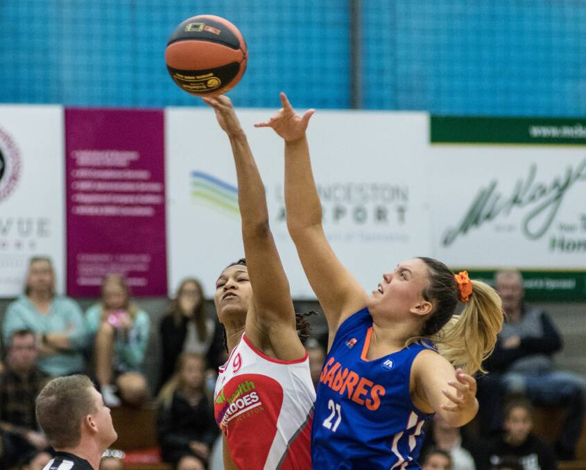 Reaching out: Launceston Tornadoes' Brittany Hodges and Ella Batish of Southern Sabres contest possession at Elphin Sports Centre. Picture: Phillip Biggs