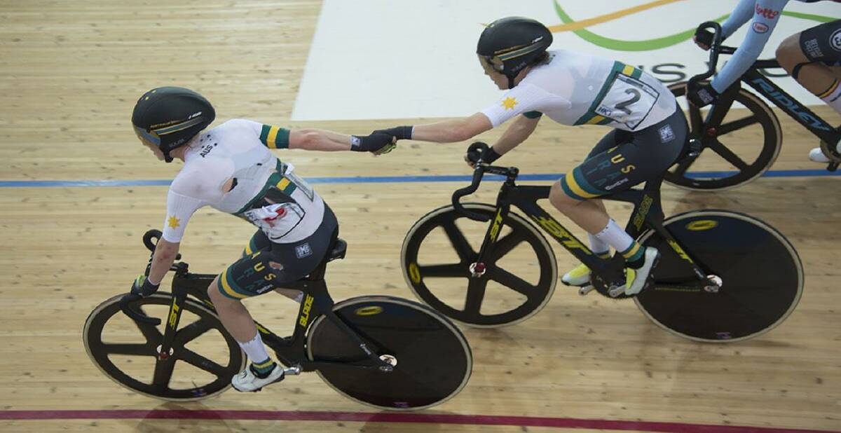 Hands up: Amy Cure (right) and Alex Manly in the women’s madison at the 2017 track world champs in Hong Kong. Picture: Casey Gibson
