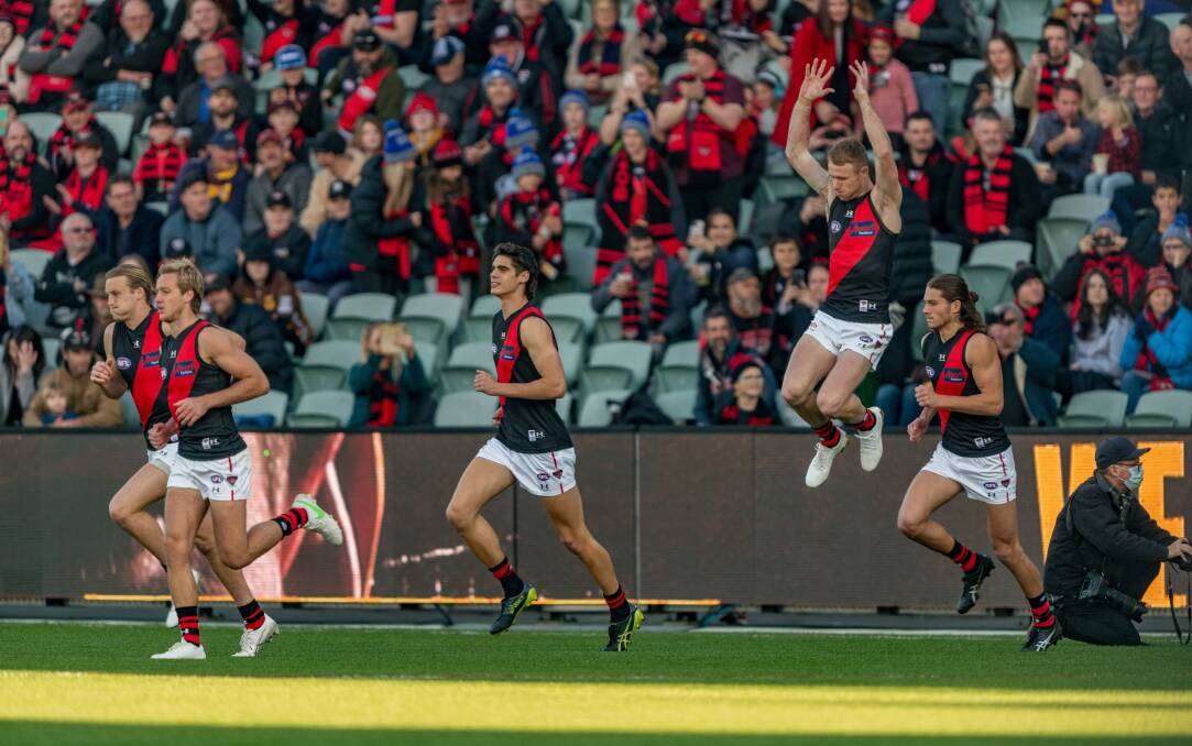 Bombs away: Essendon players run out onto Launceston's UTAS Stadium two months ago. The Bombers return in a historic weekend for Tasmanian footy. Picture: Phillip Biggs