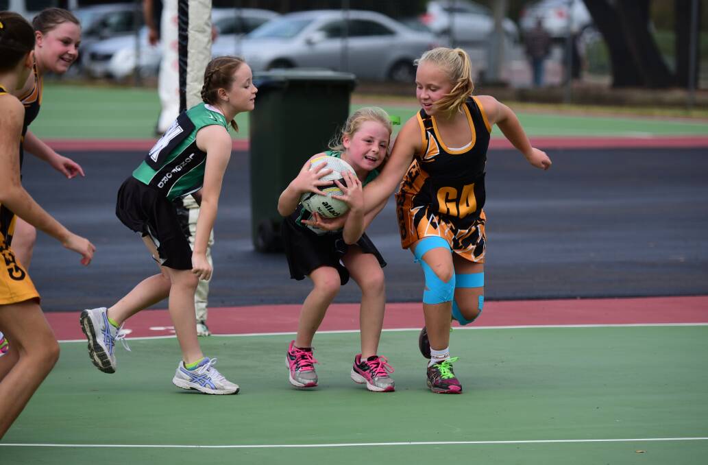 Longford Tigers defenders Cheyenne McKinnell and Chloe Gibbons compete with Gee Tees Glory goal-attack Lottie Johnston.