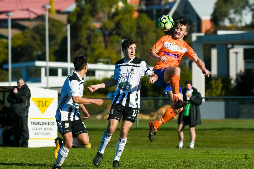 Fry up: Launceston City's Rhys Goold and Ryan McCarragher, of Riverside, challenge for possession in last week's Northern derby. Picture: Phillip Biggs