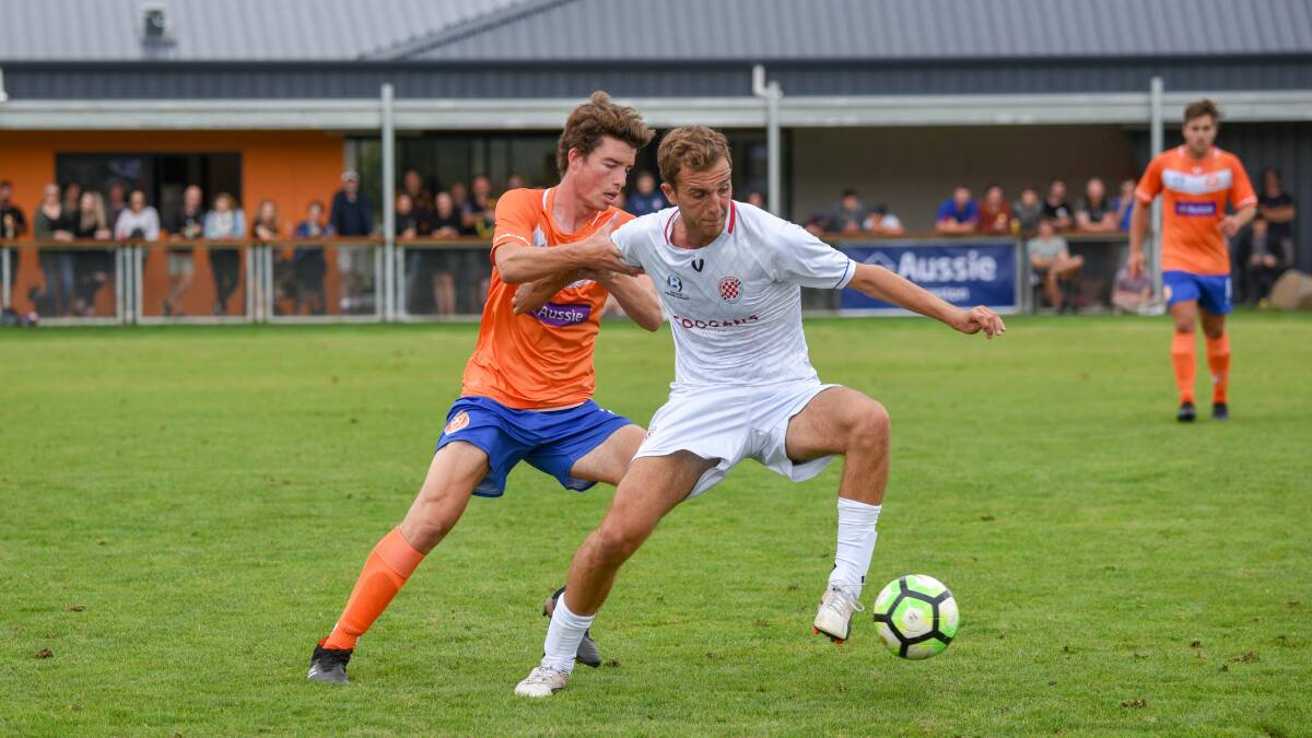 Will power: Riverside's Will Humphrey shadows Glenorchy's Alessandro Bellini in the sides' NPL Tasmania clash on Saturday. Picture: Paul Scambler