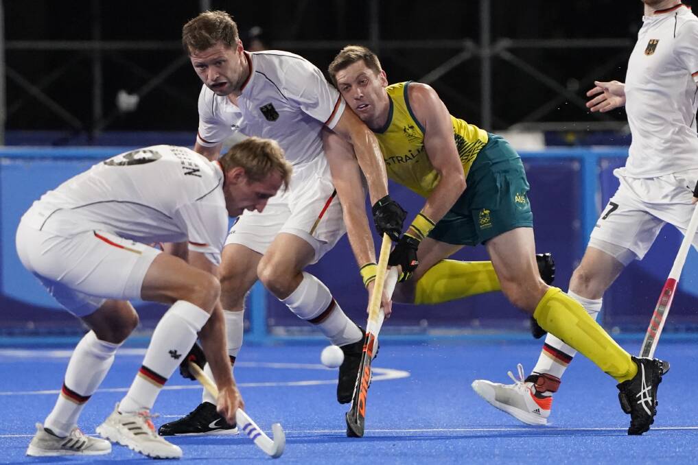 Sticking with it: Eddie Ockenden in the thick of the action in the Olympic hockey final against Belgium. Picture: AP