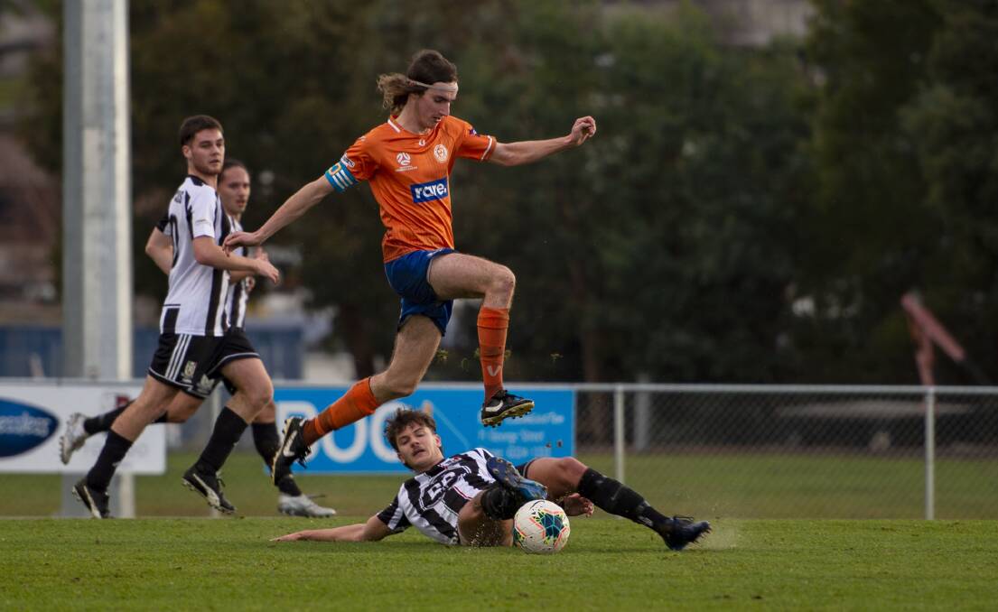 FLYING HIGH: Riverside's Daniel Shaw evades a tackle against Launceston City. Pictures: Floyd Jones