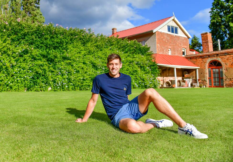 Green grass of home: Eddie Ockenden relaxing at his family home in Moonah. Pictures: Scott Gelston