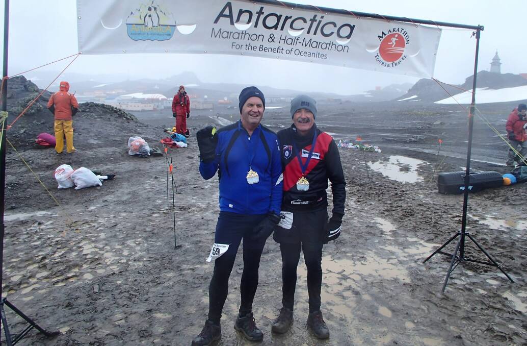 Michael Booth with Dave MacFarlane completing the Antarctica Marathon in 2014.