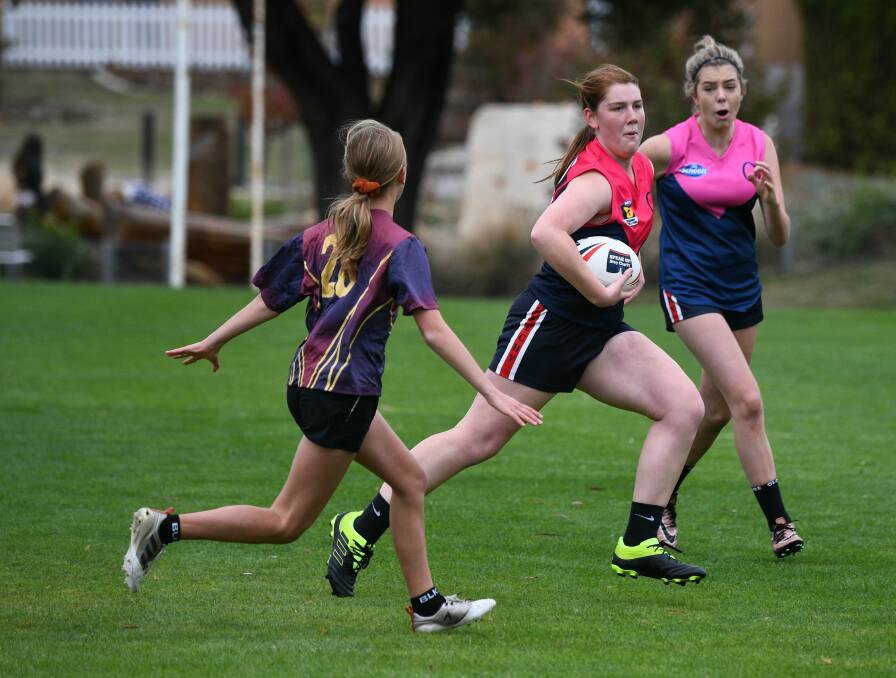 Giving chase: Queechy's Chloe Daw and Olivia Summers are pursued by Riverside's Elise Bransden. Picture: Paul Scambler