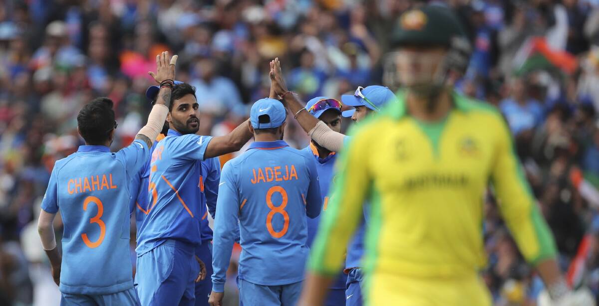 Oval and out: Indian players celebrate the dismissal of Australia's Marcus Stoinis during the Cricket World Cup match at The Oval in London. Picture: AP