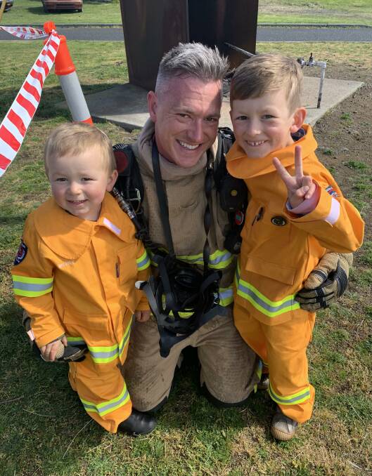 Alex Crawford at his Tasmania Fire Service graduation with his sons Monty, 3, and Oliver, 6. Picture: supplied 