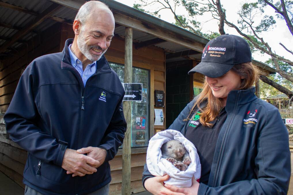 Primary Industries Minister Guy Barnett, Bonorong Wildlife Sanctuary handler Kate Pickett and Lenny the wombat. Picture: supplied 