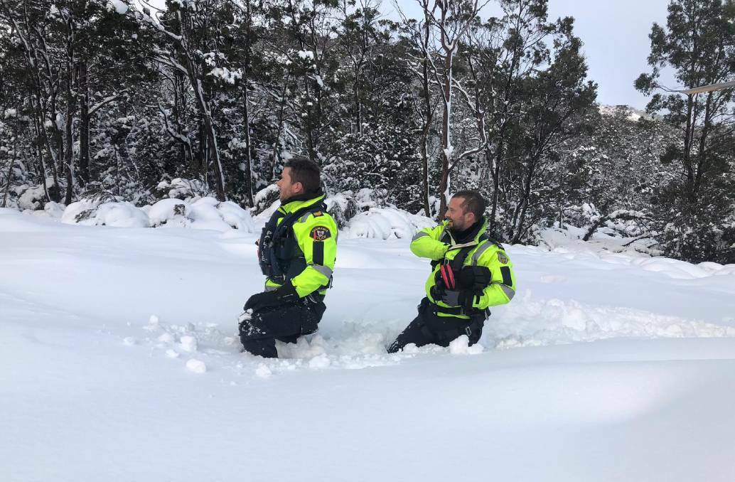 CHALLENGING CONDITIONS: Search and rescue team members wade through snow at Lake St Clair National Park. Picture: Tasmania Police
