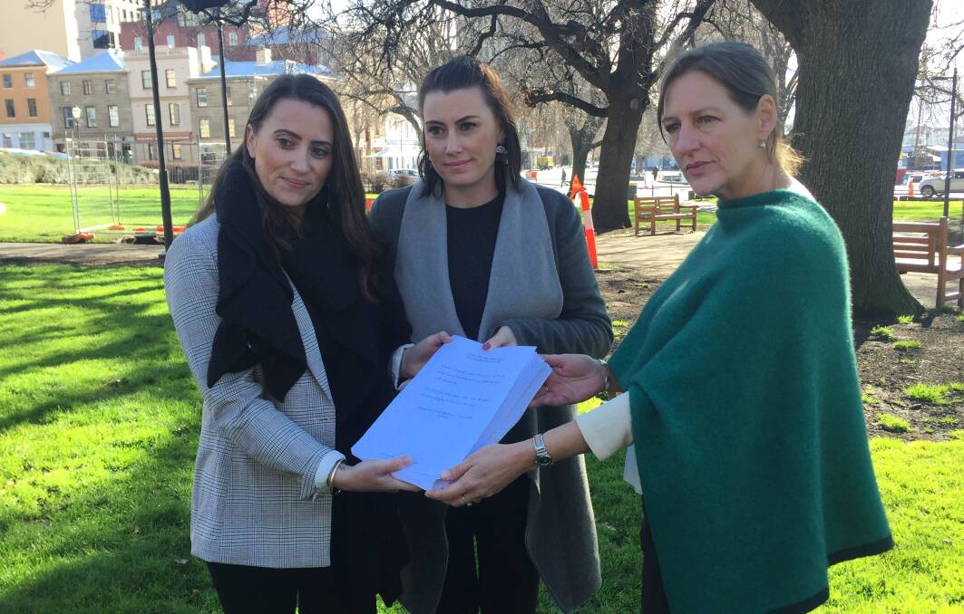 CHANGE: Voluntary assisted dying advocates Jacqui and Natalie Gray and Greens leader Cassy O'Connor with the petition. Picture: Emily Jarvie