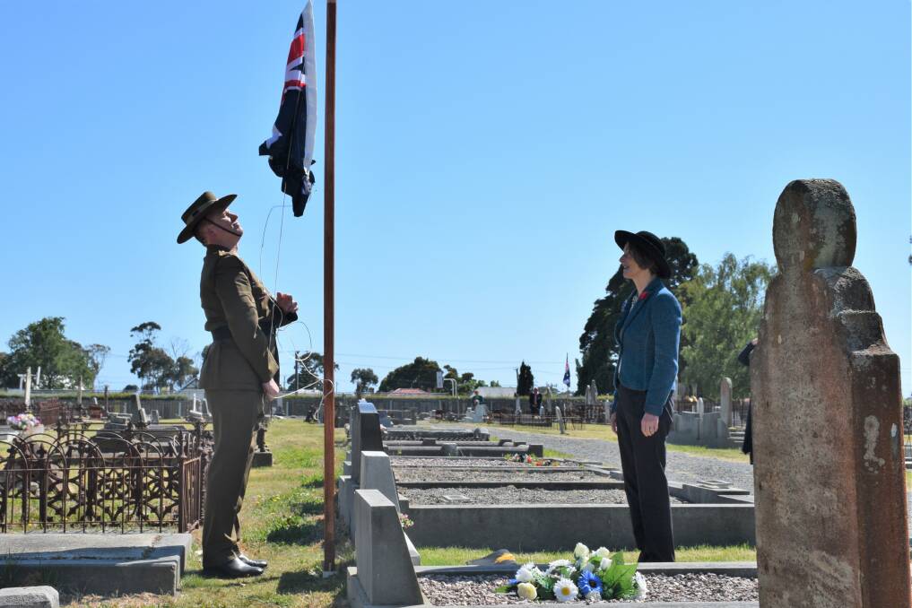 Tasmanian Governor Kate Warner helps unveil a veteran's headstone at a Remembrance Day service in Ulverstone cemetery. Picture: Lachlan Bennet
