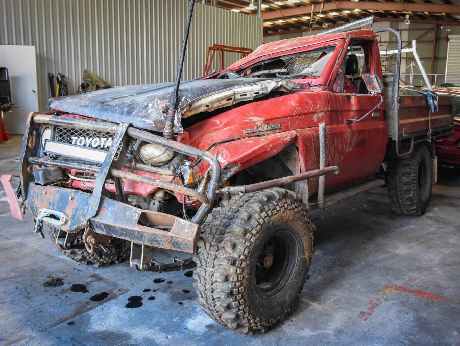 BIG RED: Ben's Landcruiser at the police garage after the crash. Picture: Paul Scambler