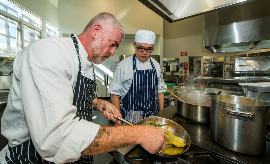 HEATING UP: Chef Alex Atala at Launceston's TasTAFE Drysdale kitchen with Commercial Cookery Cert III international student Vernon Leu. Pictures: Phillip Biggs 