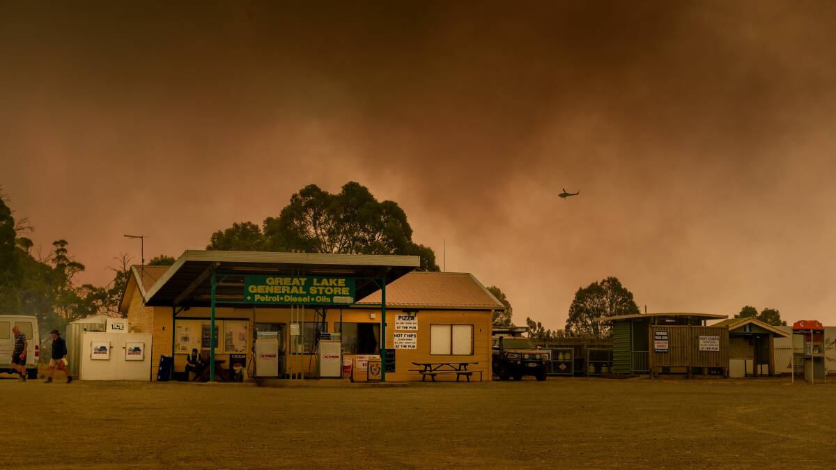 BUSHFIRE: Smoke haze blankets the sky above the Great Lake general store on Tuesday. Picture: Paul Scambler