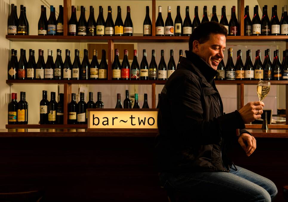 CHEERS: Bar Two owner Nathan 'Nate' Cairns samples a Tasmanian wine ahead of the official opening. Picture: Scott Gelston