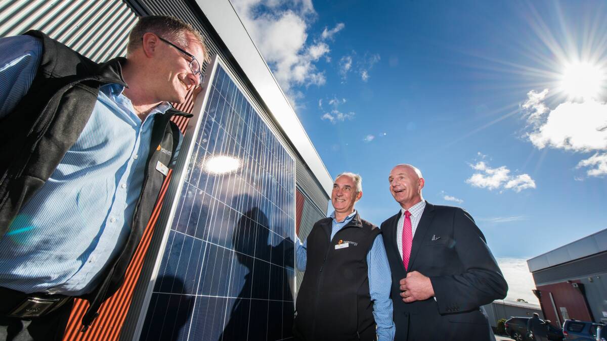 SOLAR SOLUTION: Nest Energy commercial manager David Hillier and general manager Mark Barnett with Tasmanian treasurer Peter Gutwein at the site of the future Merino Street Solar Park. Picture: Phillip Biggs