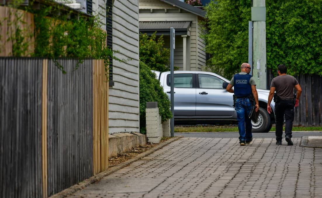 Tasmania Police detectives leaving the house at Herbert Street, Invermay. Picture: Scott Gelston