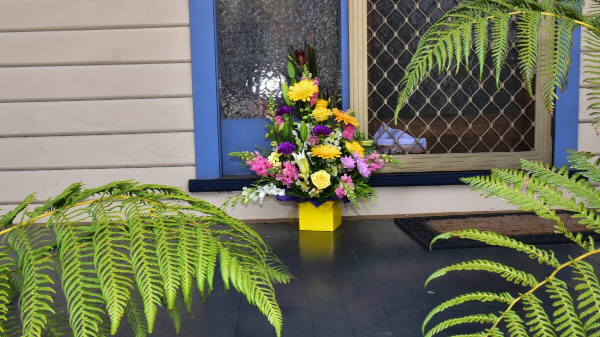 FAREWELL: A Keane Street neighbour placed a box of flowers at the door of alleged murder victim Veronica Corstorphine. Picture: Neil Richardson