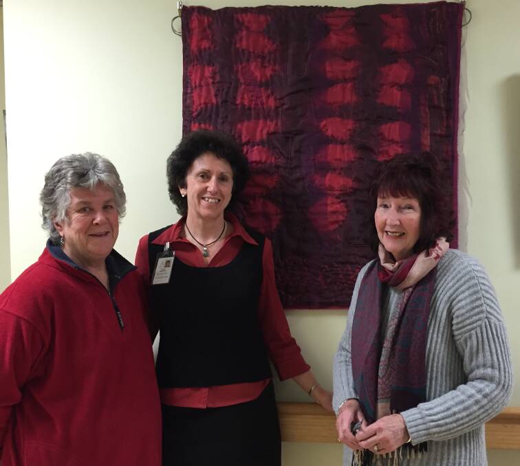 AWARENESS: Volunteer advocate Sheila Stevenson, Deloraine District Hospital admin support officer Isabelle Vescovo and artist Lorraine Weaver with her work Enchained.