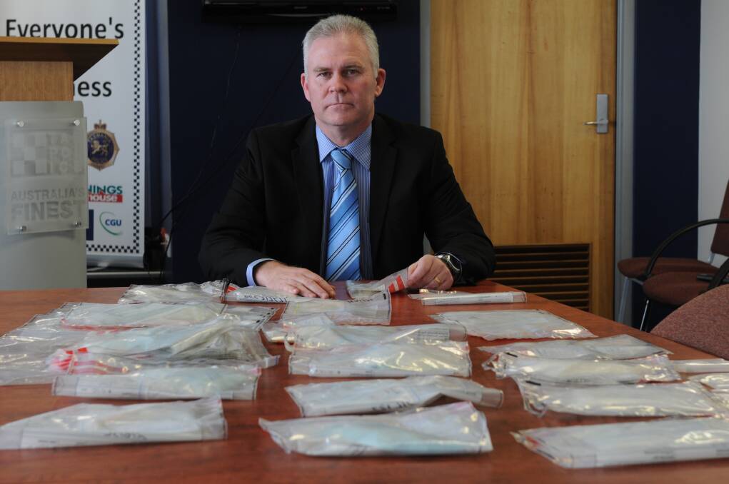 HAUL: Inspector Scott Flude with some of the seized 800 grams of ice in August 2011.