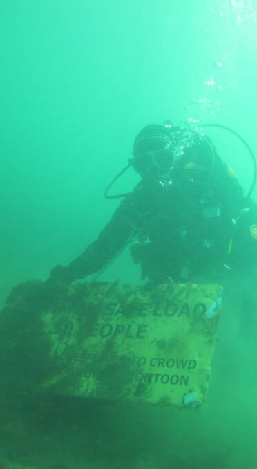 DIVE: Masa Tatsumi discovers a road sign during a dive at Kelso. Picture:Grace Ho