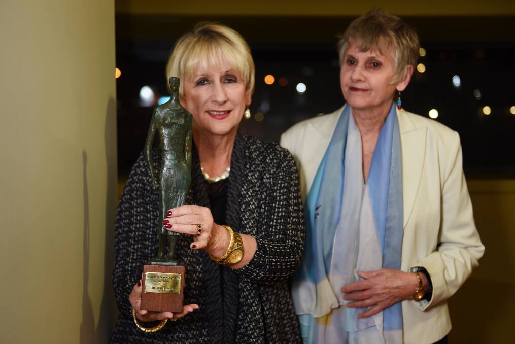 HANDOVER: The 2014 Alice Award winner, Libby Hathorn hands the trophy to Society of Women Writers Tasmania Inc secretary Ros Sydes to award to the 2016 winner. Picture: Scott Gelston
