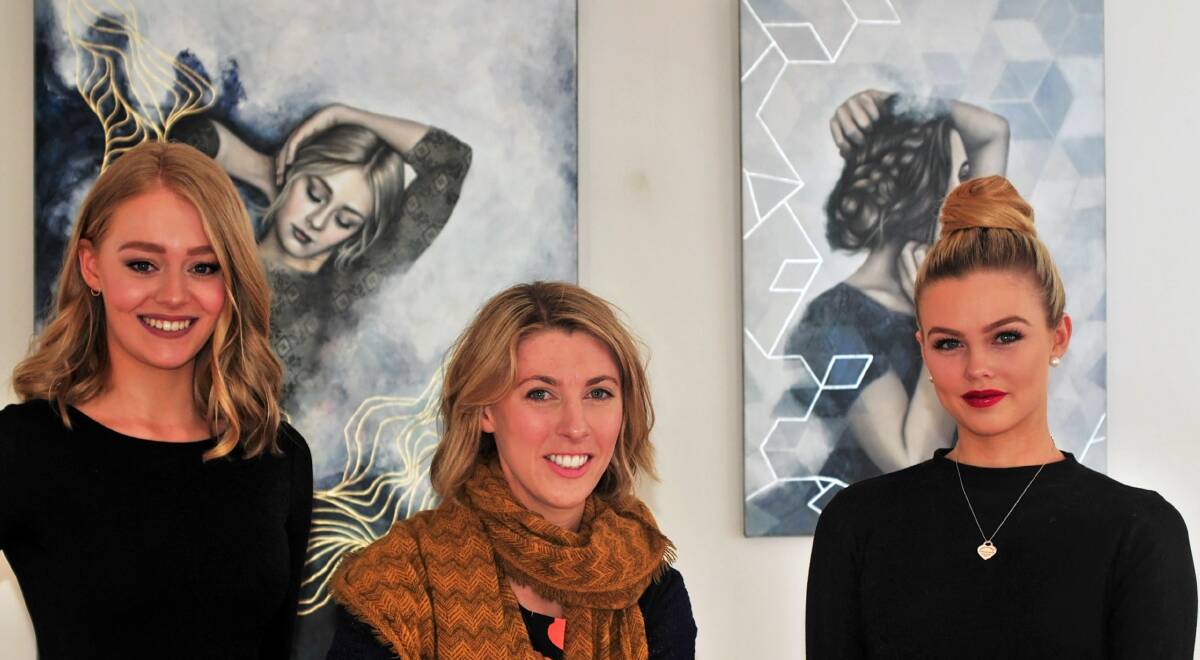 TRADITION: Artist Emily Blom (centre), with Sue Rees models Shanae Gibson and Hannah Russell at Hallmark Gallery. Picture: Phillip Biggs