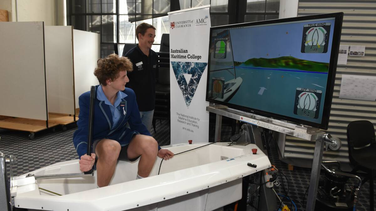 Kings Meadows student Kaiden Page tests his sailing ability with AMC naval architect student Jordan Banks.