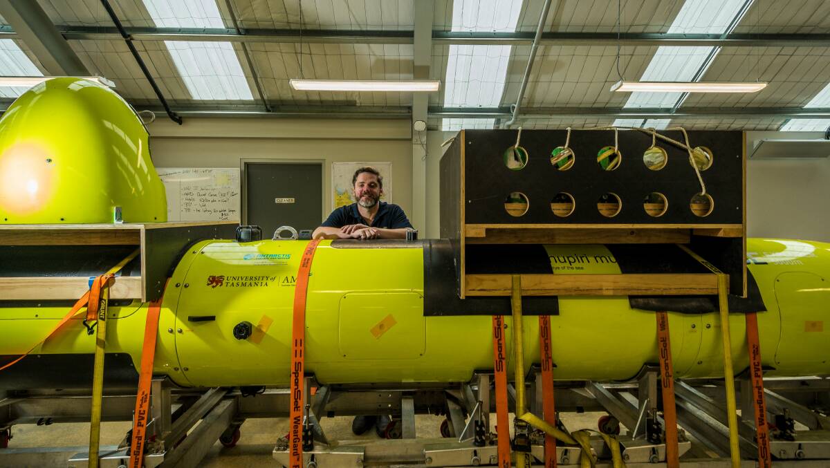 WORLD LEADER: AMC autonomous underwater vehicle (AUV) facility manager Peter King with Nupiri Muka, a seven metre-long 1.5 tonne AUV. Picture: Phillip Biggs