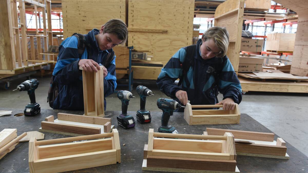 CRASH COURSE: Kings Meadows students Luke Perkins and Bailey Mitchell make a tool caddy at the Create My Career day at UTAS. Pictures: Paul Scambler