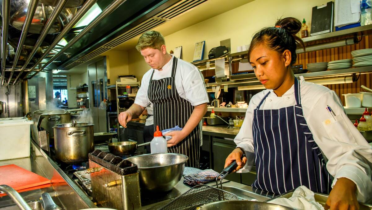 PREPARATION: Third-year apprentice chef Matthew Brown and first-year student Kaye Villagraci work in the kitchen at Josef Chromy, which will host the Great Chef series. Picture: Scott Gelston 