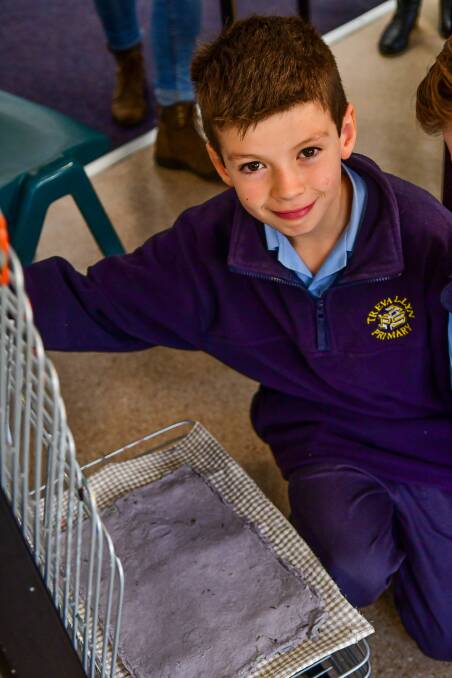 Trevallyn Primary School grade 5 pupil Wesley Lanham makes his paper from old Examiners.