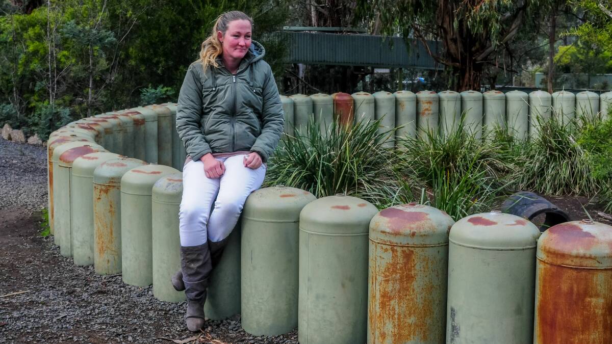 HIS MARK: Tasmania Zoo head zookeeper Emma Morgan at the gas bottle wombat enclosure made by Dick Warren. Picture: Neil Richardson
