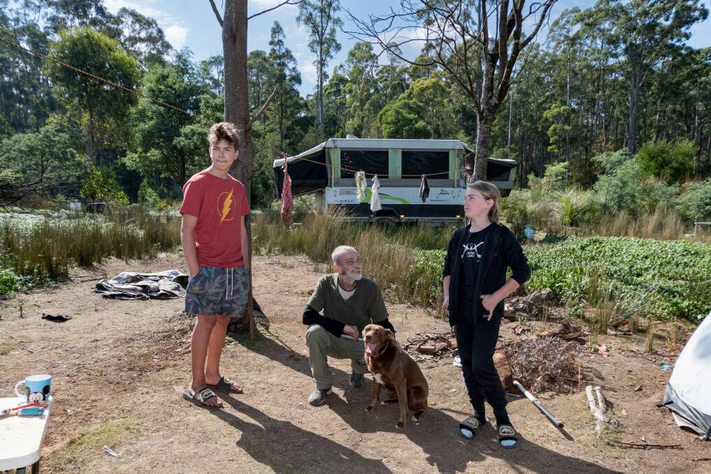 HELPING HAND: Edward Whiteside with his sons Jasper, 14, and Sheamus, 13, at their campsite at Weetah, where they have lived in a campervan and tents for four years. Picture: Phillip Biggs