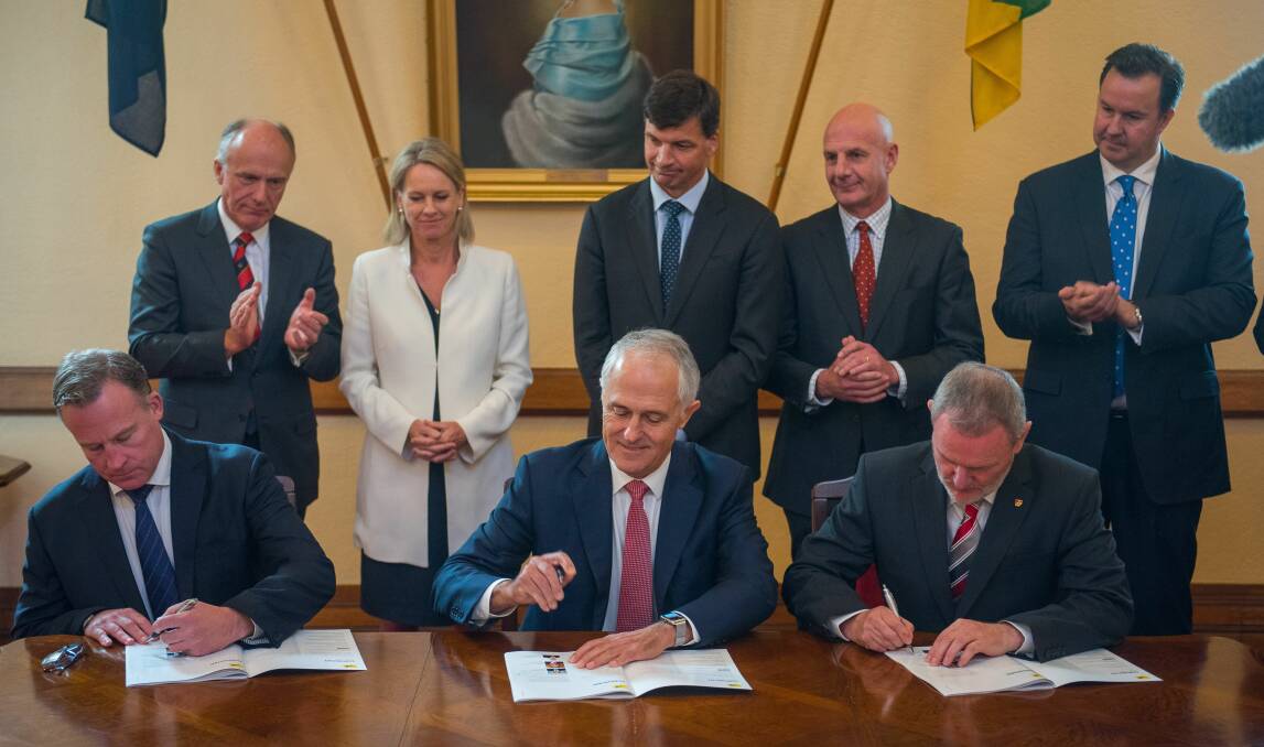 PROGRESS: Prime Minister Malcolm Turnbull signs the Launceston City Deal with Premier Will Hodgman and City of Launceston mayor Albert van Zetten in 2017.