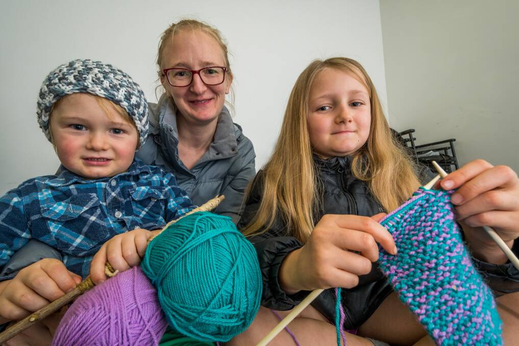 Samantha Buchanan, of Trevallyn, with Sebastian, 4, and Amelia, 8, with their knitting  at one of the meet-ups at the Door of Hope.