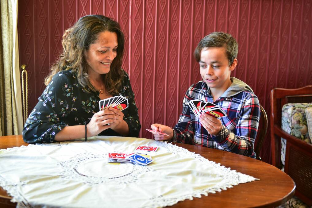 Wonderland Retreat coordinator Pearl Stuparich and client Byron Kern, 16, of Somerset, play a game of Uno.