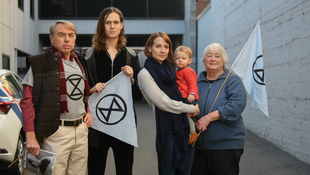 REBELS: Extinction Rebellion group members Steve Saunders, Zoe Saltz, Amy Dillon, with 12 month old daughter Nina, and Kim Nielson-Creeley. Picture: Paul Scambler