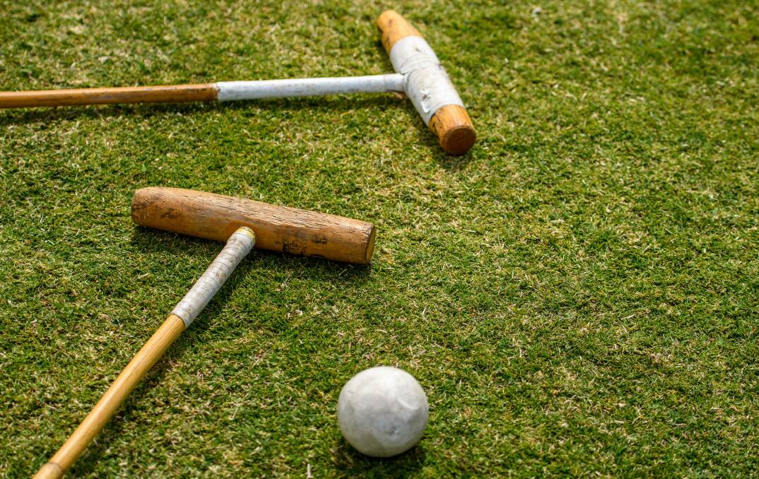 TOOLS OF THE TRADE: The game is played by two opposing teams with the objective of scoring goals by hitting a small hard ball with a long-handled wooden mallet.