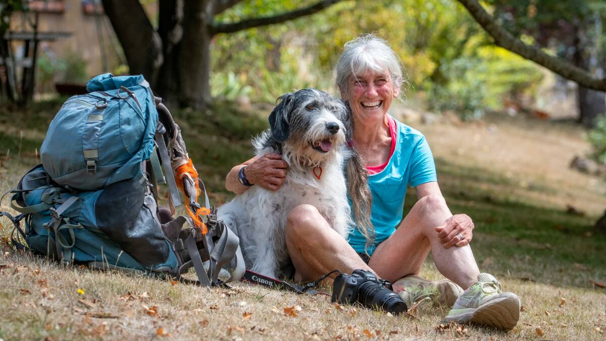 IN HER ELEMENT: Louise Fairfax with her dog Tess and her camera and bush walking pack. Her pack can weigh up to 13 kilograms, and that doesn't include her camera gear, which she usually straps to her front. Picture: Paul Scambler