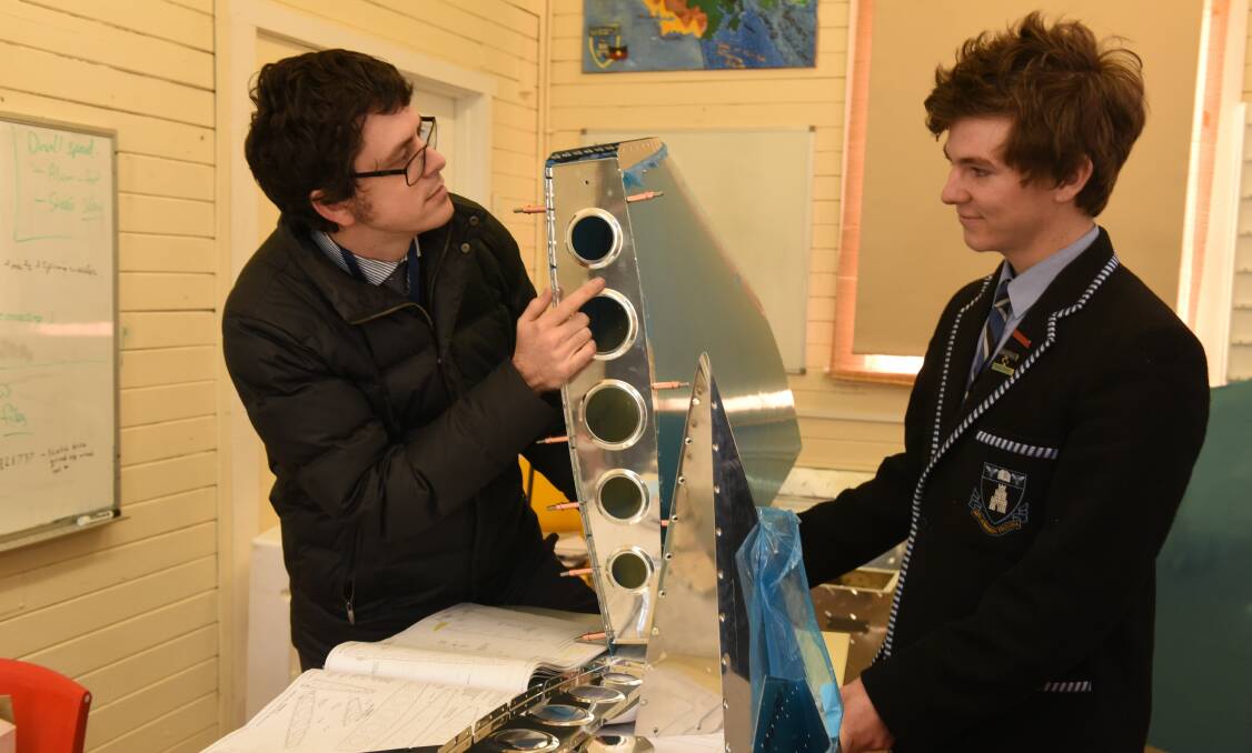 ONE RIVET AT A TIME: Launceston Church Grammar School student George Gray and teacher Cameron Rogers examine pieces of the light sport aircraft the students are building as an extra-curricular activity. Picture: Paul Scambler