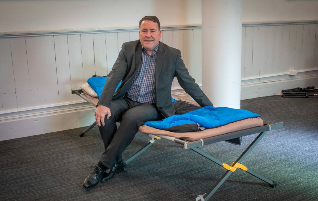 OPEN TO CHANGE: City Mission chief executive Stephen Brown on one of the camp beds at Safe Space Launceston. Picture: file