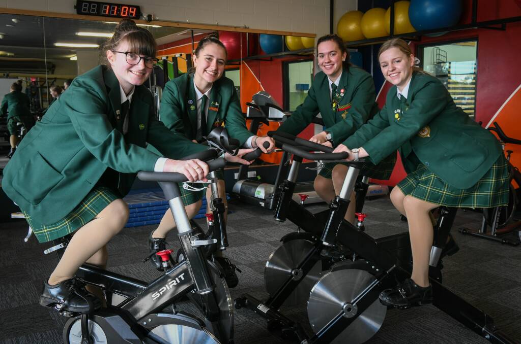 PEDAL POWER: St Patricks College Lap it Up committee members Sarah East, Maddie Johnston, Peata Bilich and Sasha Massey get in some exercise bike time. Picture: Paul Scambler 