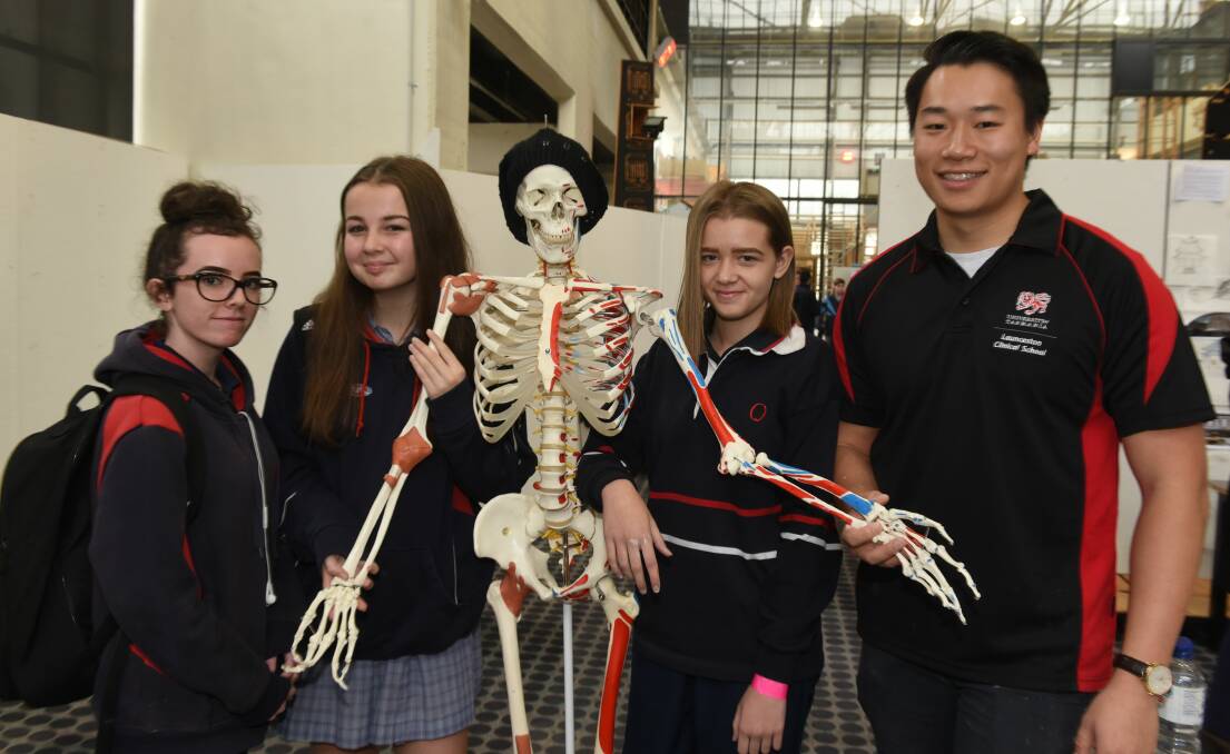 Queechy High students Heidi Cook, Chloe Allen and Jade Clarke with Launceston Cliical School student Luke Yang and Steve the skeleton.